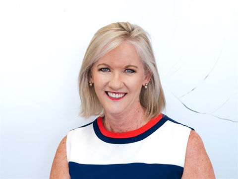 Jodie Leonard is wearing a white dress with a blue horizontal stripe and a red collar, she is smiling directly at the camera.  Jodie is a Great Ocean Road Coast and Parks Authority Board member.
