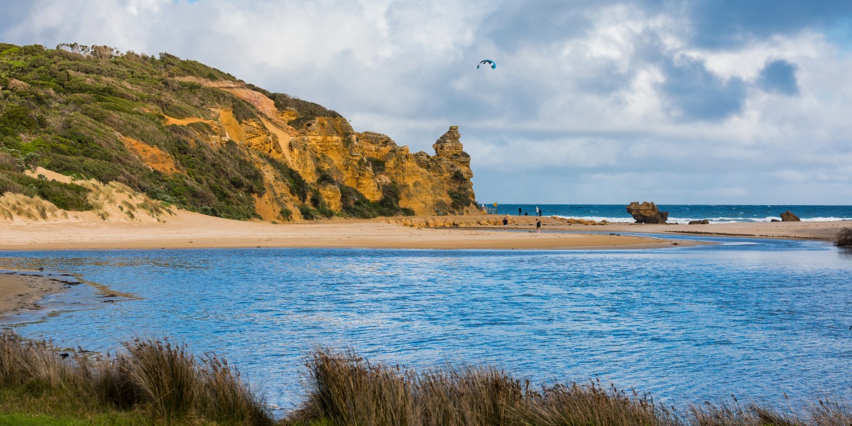People walking up the beach at Aireys Inlet.